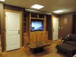 Game Room Located Downstairs with Flat Screen TV, Sofa and Over Size Chair with Ottoman